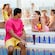 A man sitting on the edge of a circular pool while chatting with a woman inside the pool